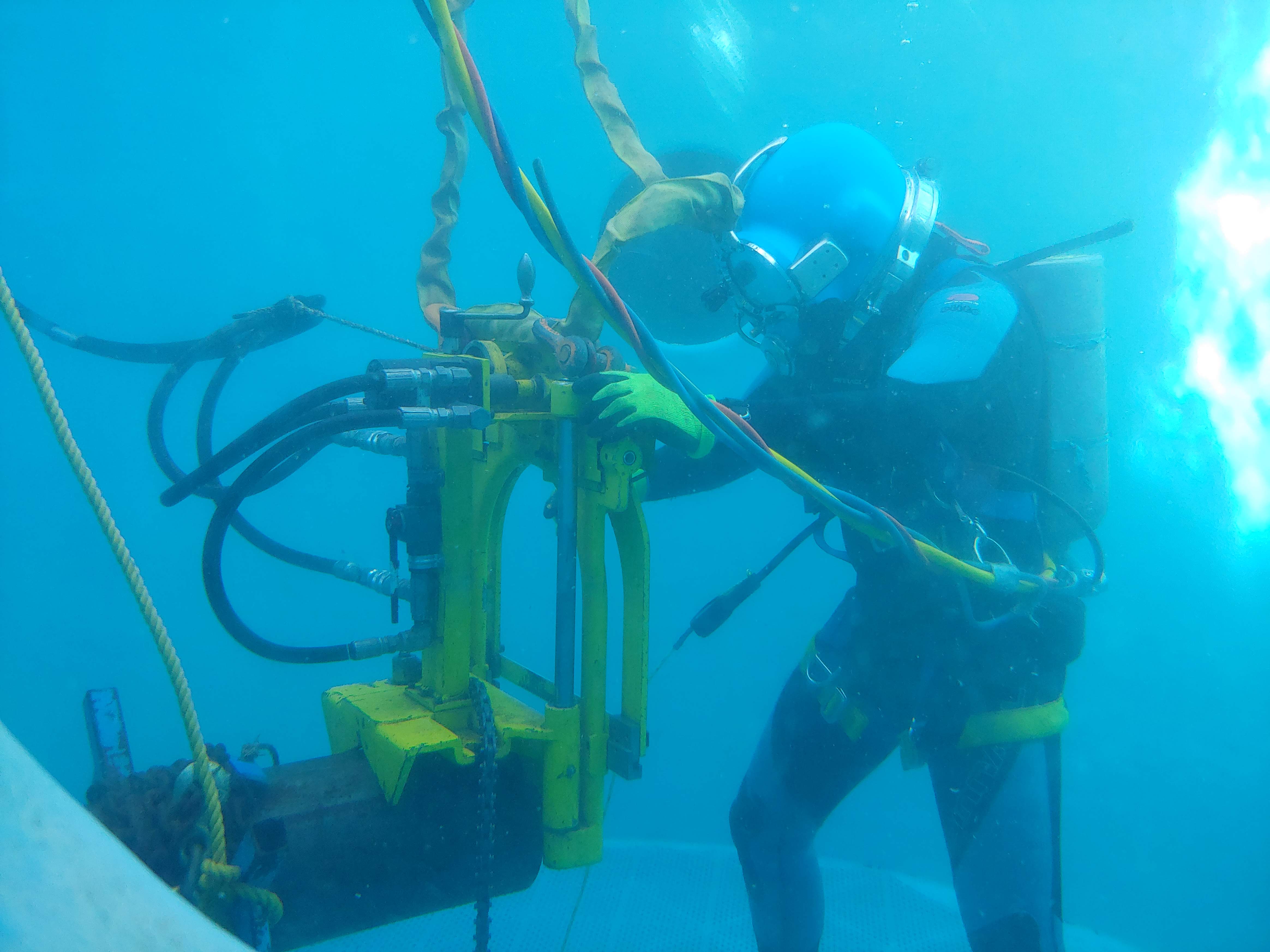 Diver working with a guillotine saw